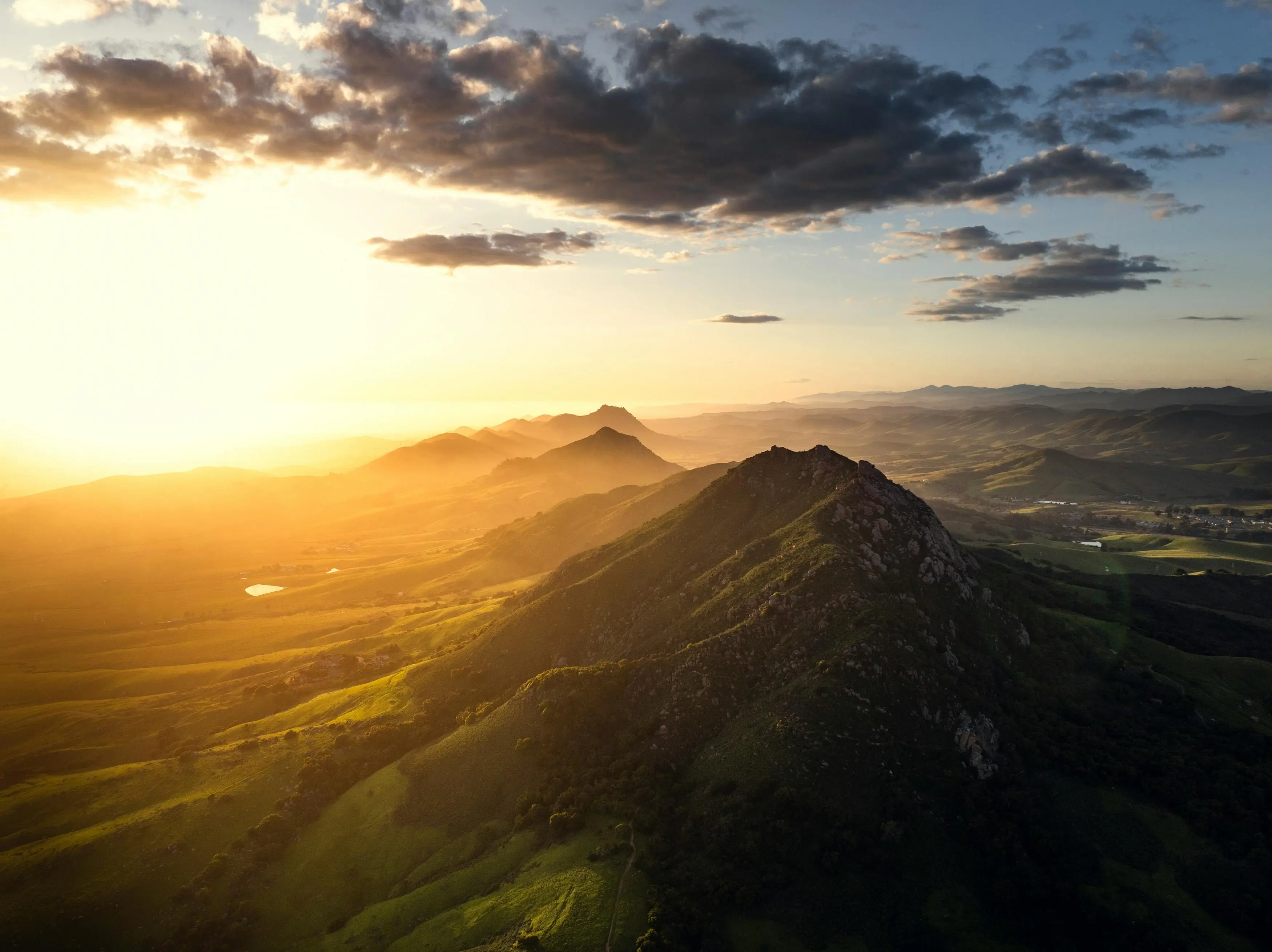 golden sunlight pouring across a mountainous landscape