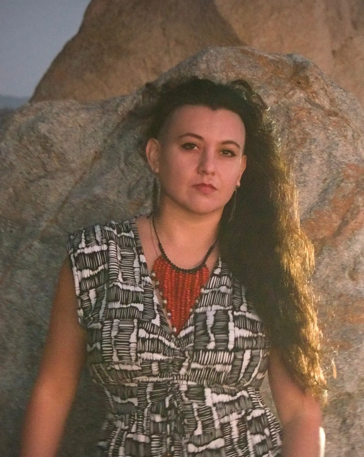 Reyah standing in front of a couple of majestic rocks